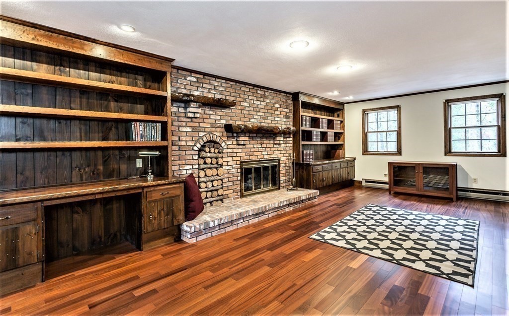 591 Neck Road Rochester, MA 02770 - Photo 18 of 32 a living room with hard wood floors and a fireplace