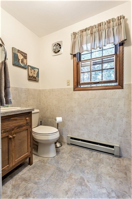 591 Neck Road Rochester, MA 02770 - Photo 19 of 32 a bathroom with a toilet a sink and a window