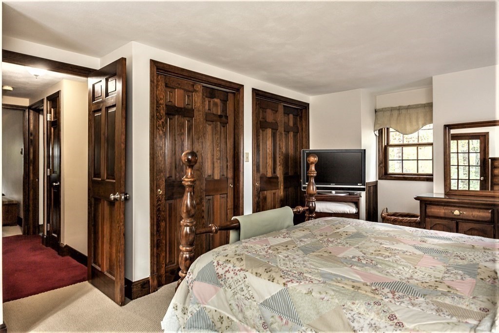 591 Neck Road Rochester, MA 02770 - Photo 22 of 32 a bedroom with a bed and a flat screen tv