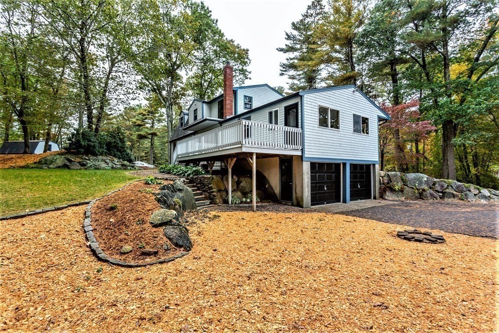 591 Neck Road Rochester, MA 02770 - Photo 25 of 32 a view of a white house with a yard and large trees