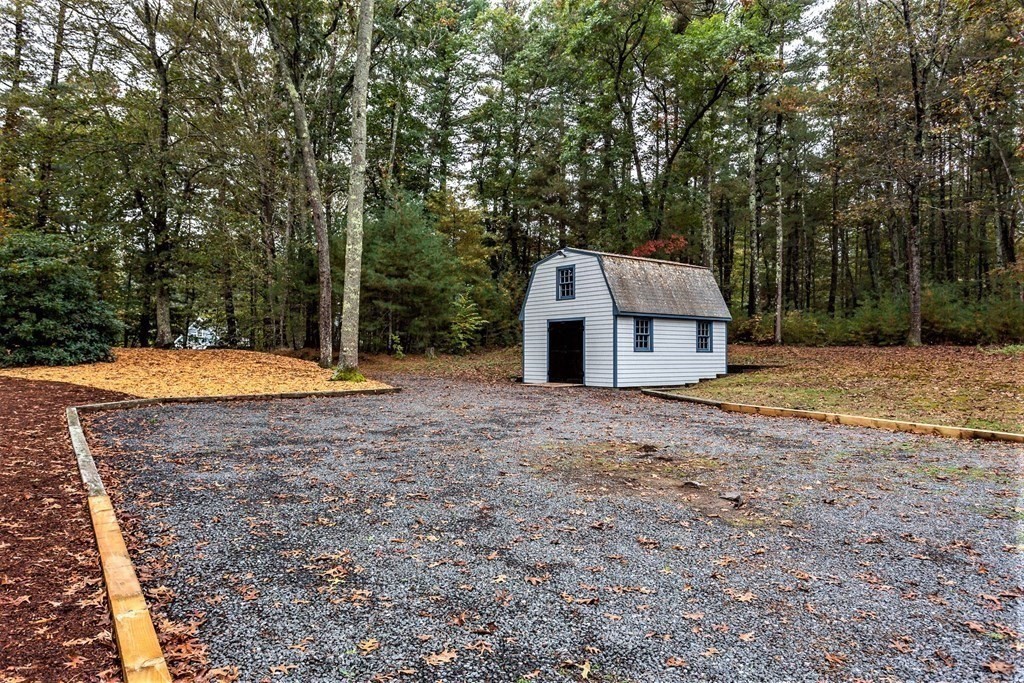 591 Neck Road Rochester, MA 02770 - Photo 28 of 32 a view of a tiny house with a backyard