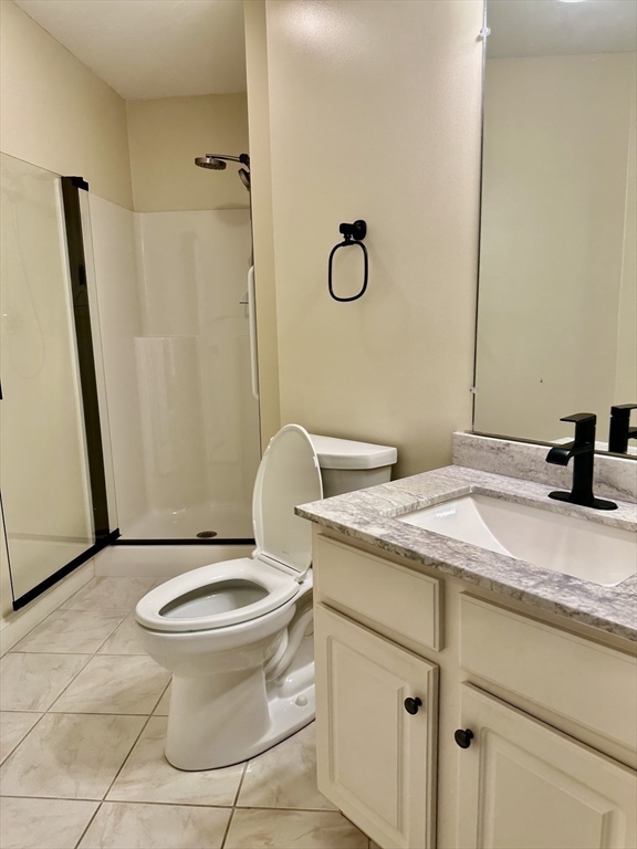 5 Mission Road, Unit 101 Chelmsford, MA 01863 - Photo 12 of 18 a bathroom with a granite countertop sink toilet and shower