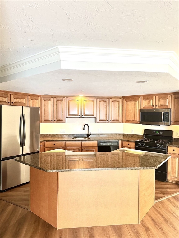 5 Mission Road, Unit 101 Chelmsford, MA 01863 - Photo 2 of 18 a kitchen with stainless steel appliances granite countertop a sink and a refrigerator