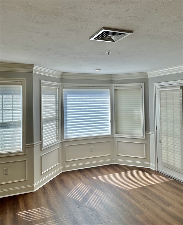 5 Mission Road, Unit 101 Chelmsford, MA 01863 - Photo 3 of 18 an empty room with wooden floor and windows