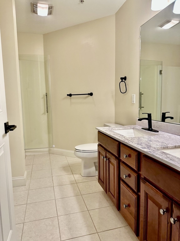 5 Mission Road, Unit 101 Chelmsford, MA 01863 - Photo 7 of 18 a bathroom with a granite countertop sink a toilet and a shower