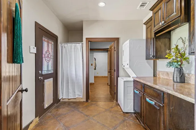 a bathroom with a granite countertop sink a mirror and a shower