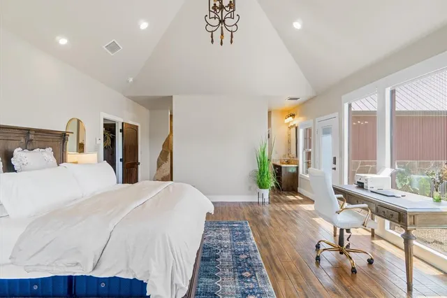 a large bedroom with bed and a large window