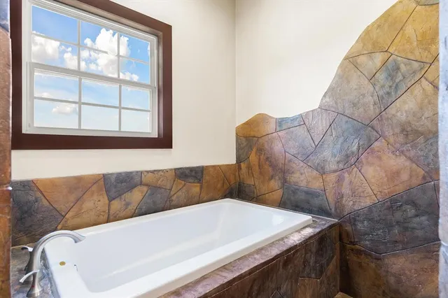 a white couch sitting in a kitchen next to a window