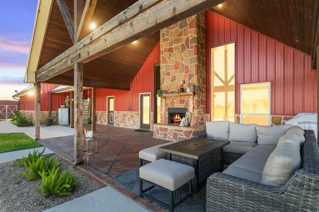 a outdoor living space with patio furniture and a large window