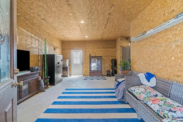 a spacious bedroom with a bed and a flat screen tv