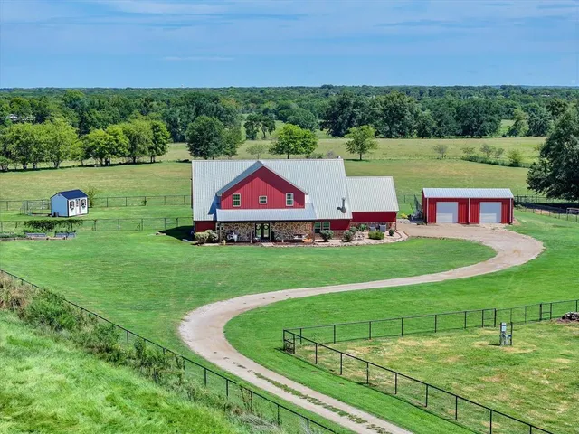 a view of green field with house in background