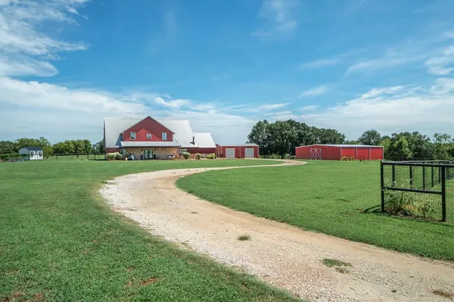 a view of green field with house in the background