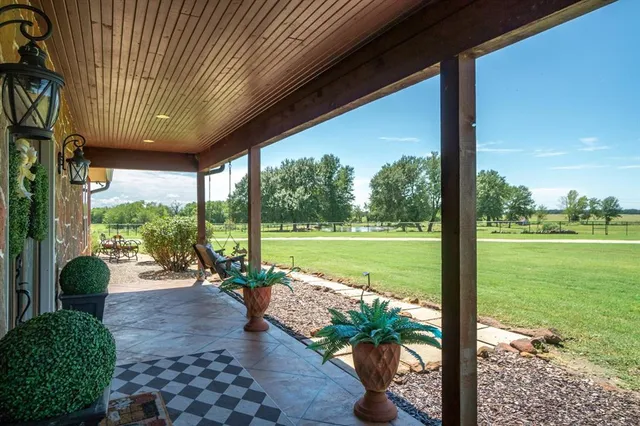 a view of a porch with furniture and garden