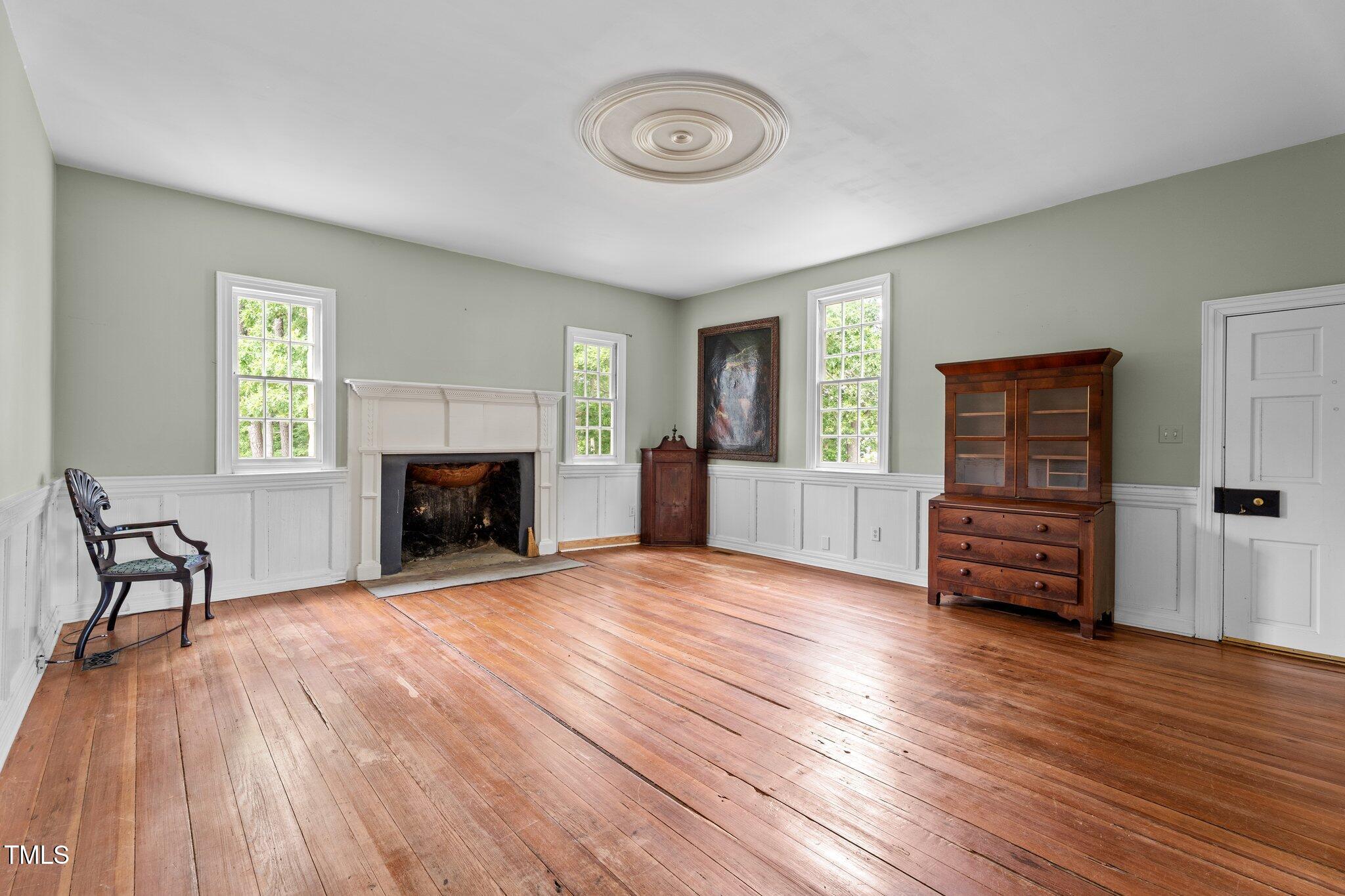7404 Halifax Road Zebulon, NC 27597 - Photo 13 of 39 a view of empty room with furniture and wooden floor