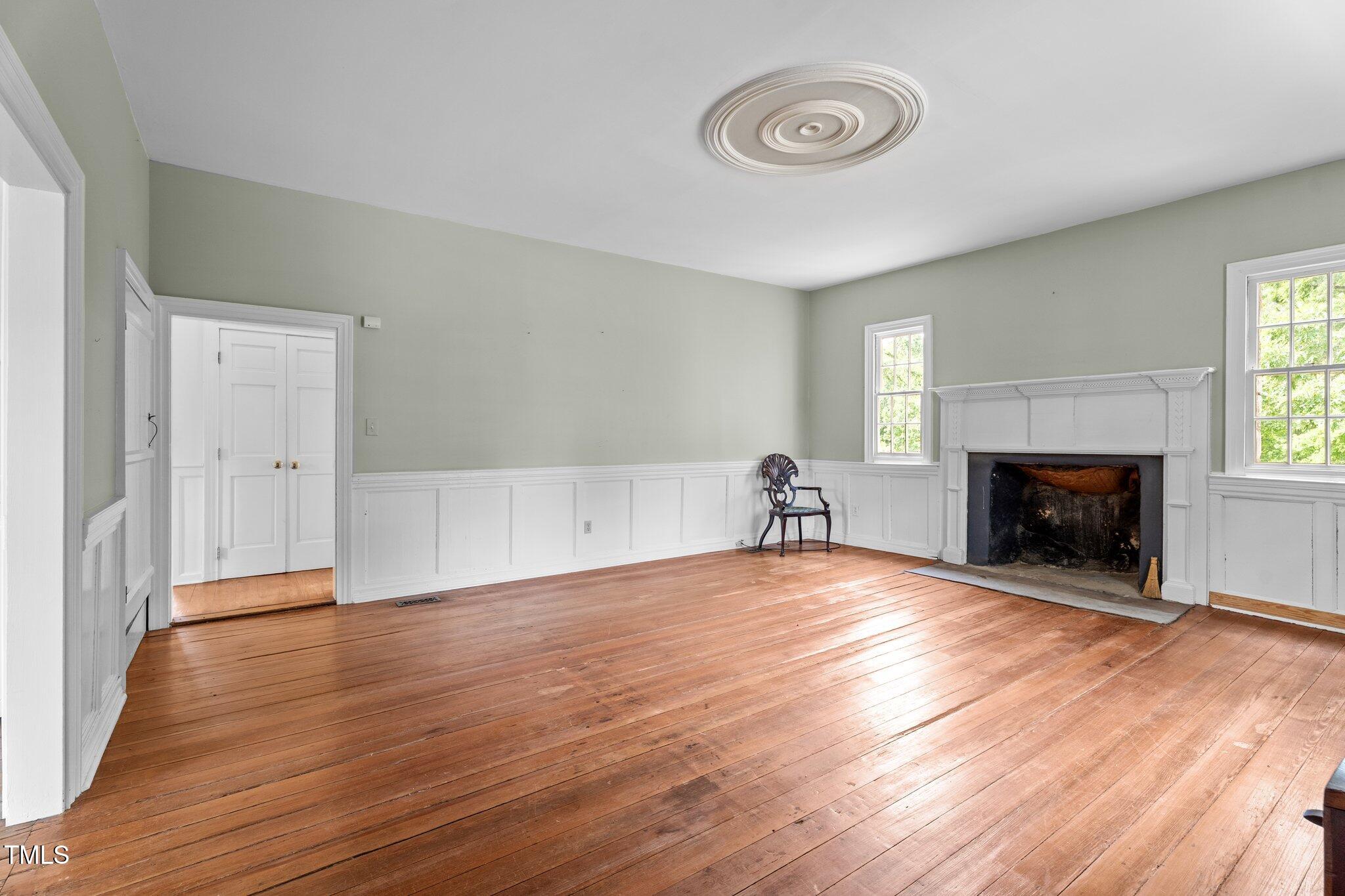 7404 Halifax Road Zebulon, NC 27597 - Photo 14 of 39 a view of empty room with wooden floor and fireplace