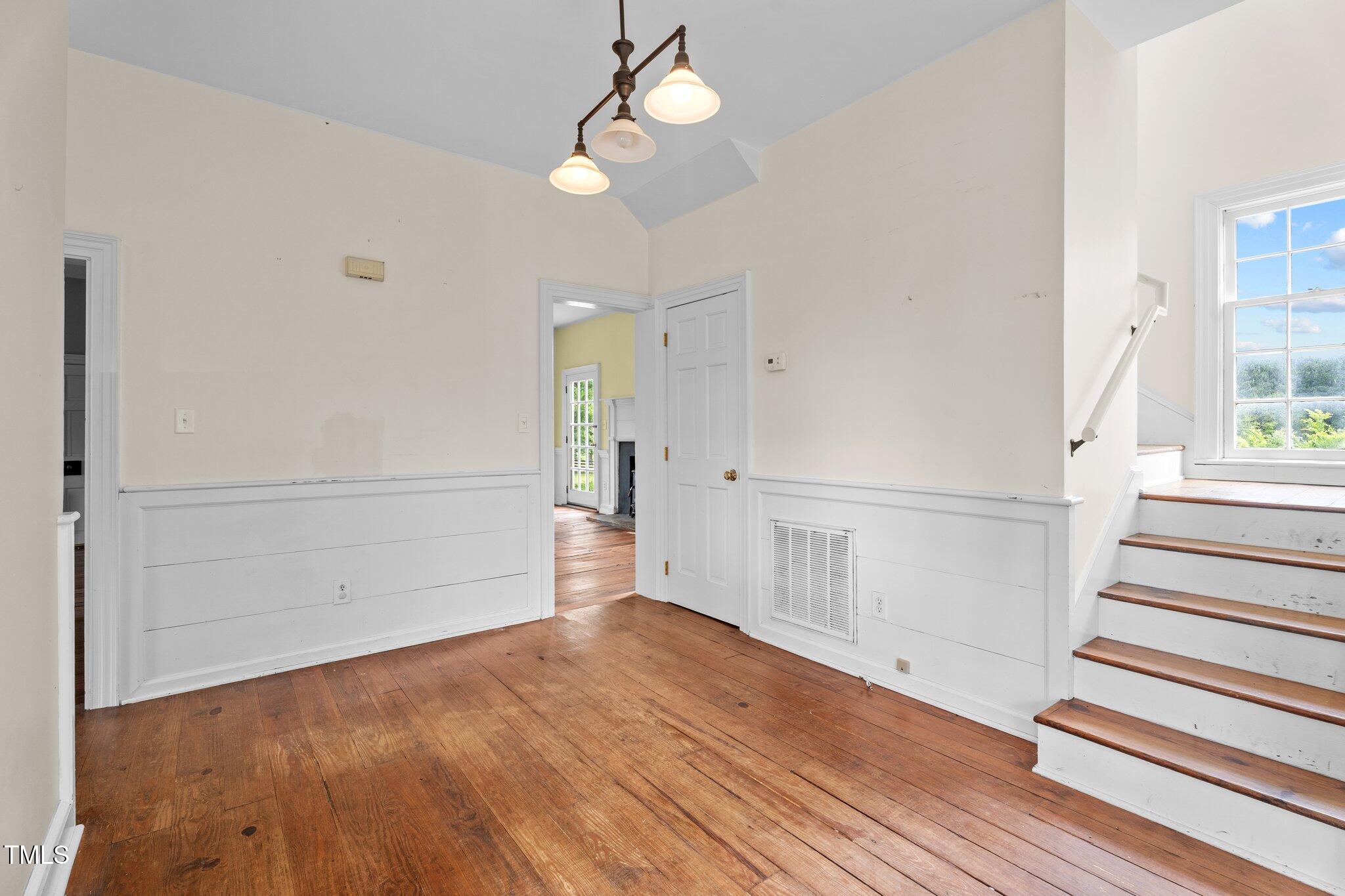 7404 Halifax Road Zebulon, NC 27597 - Photo 17 of 39 a view of an empty room with wooden floor and window