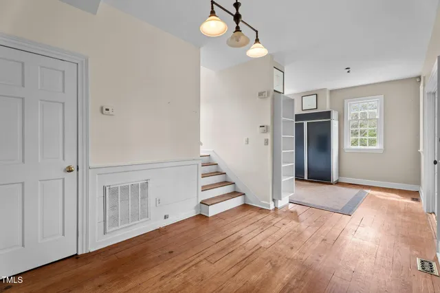 wooden floor in an empty room with a window and wooden floor