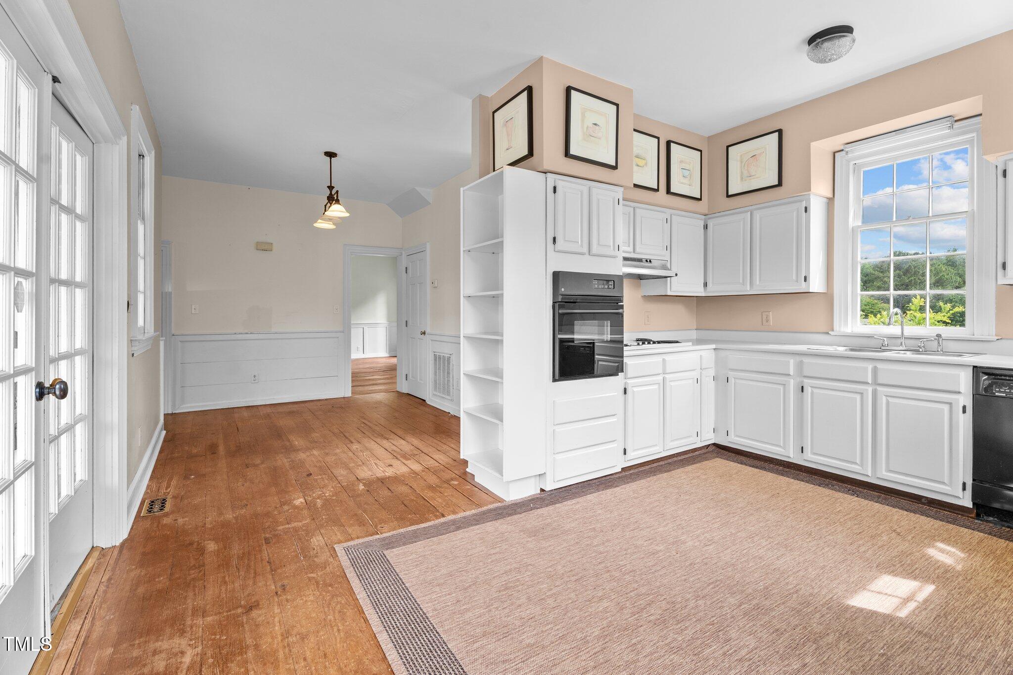 7404 Halifax Road Zebulon, NC 27597 - Photo 19 of 39 a kitchen with cabinets and window