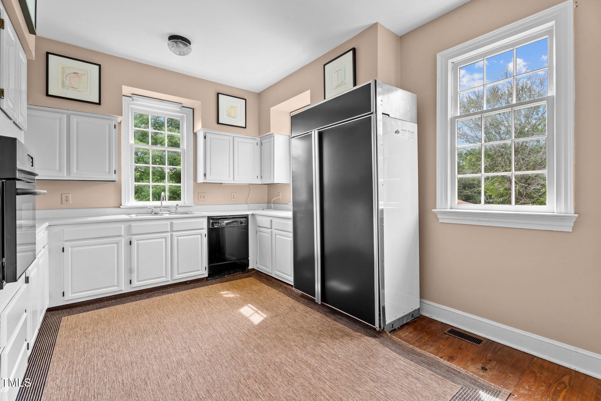 7404 Halifax Road Zebulon, NC 27597 - Photo 21 of 39 a kitchen with white cabinets and window