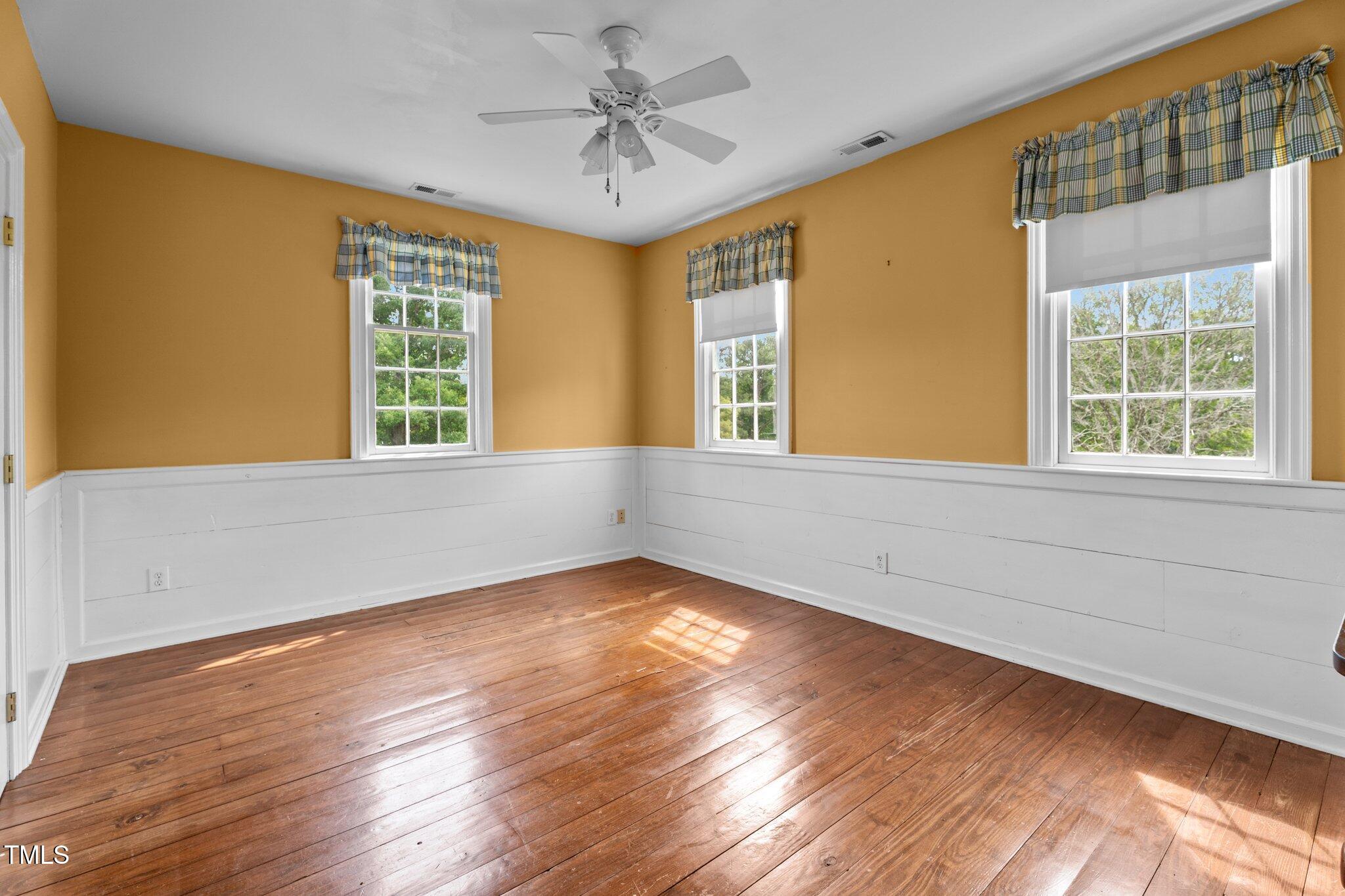 7404 Halifax Road Zebulon, NC 27597 - Photo 24 of 39 a view of an empty room with a window and wooden floor