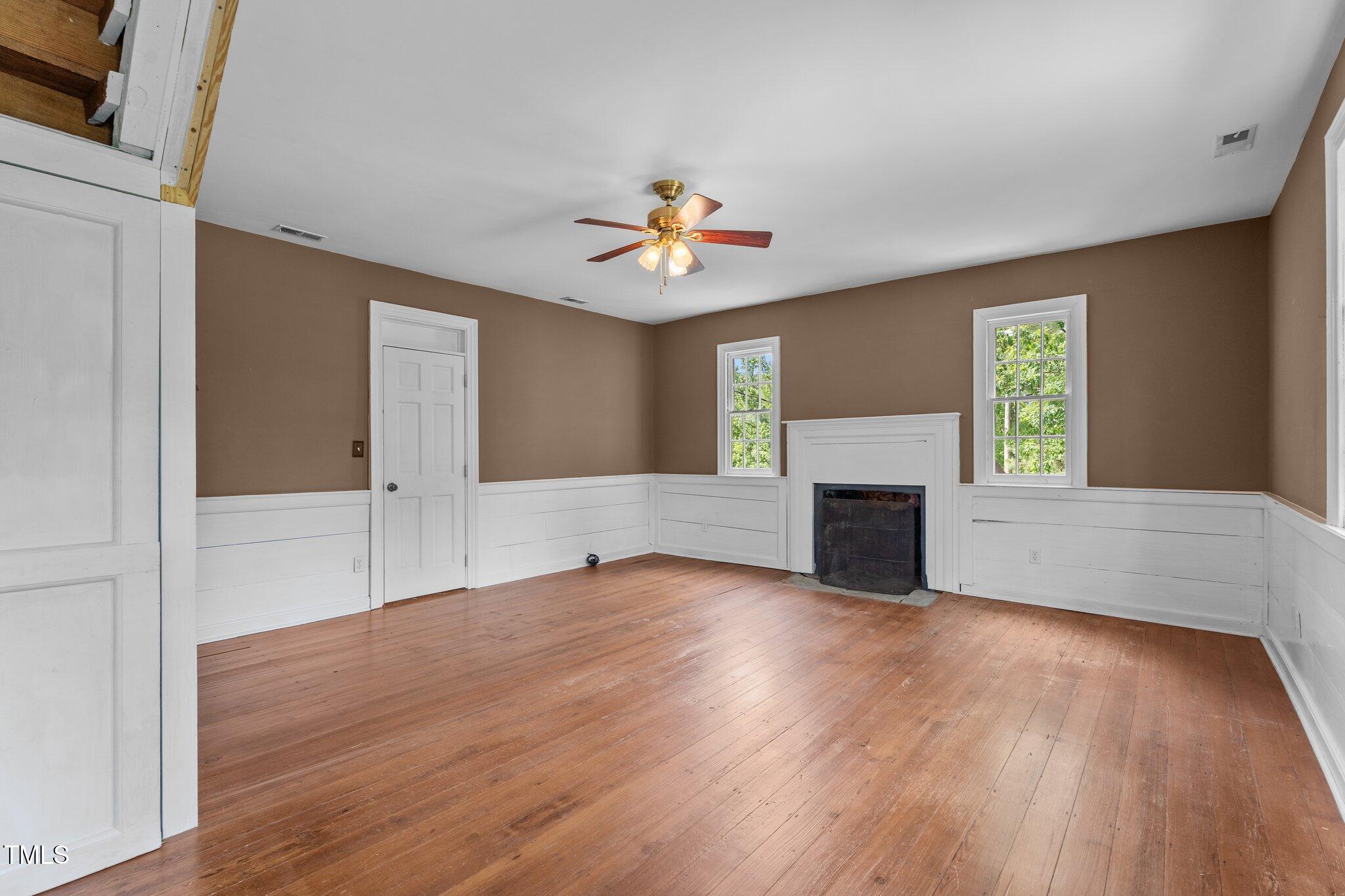7404 Halifax Road Zebulon, NC 27597 - Photo 30 of 39 a view of an empty room with window and wooden floor