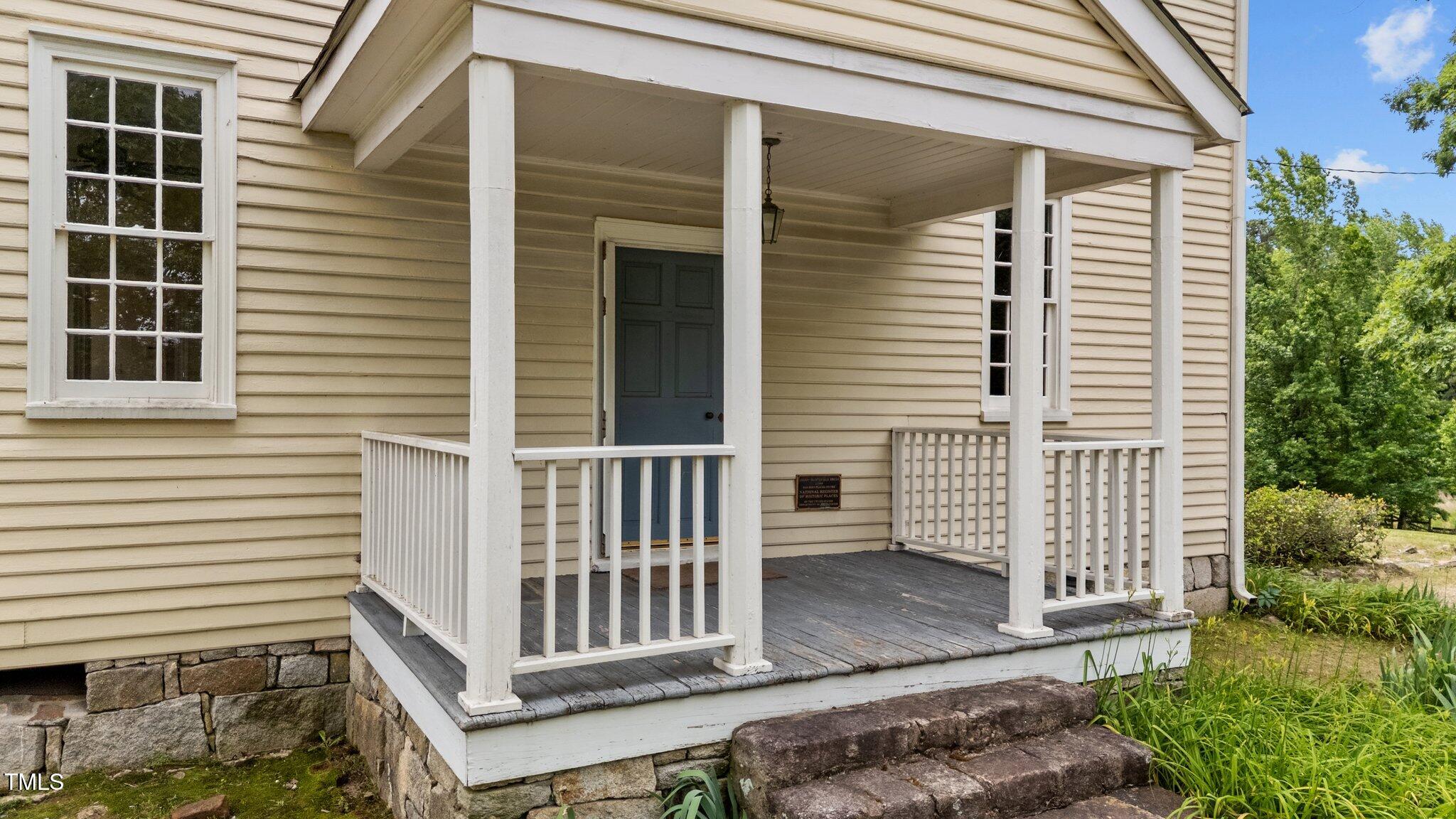 7404 Halifax Road Zebulon, NC 27597 - Photo 3 of 39 a view of a house with a small deck and a garden