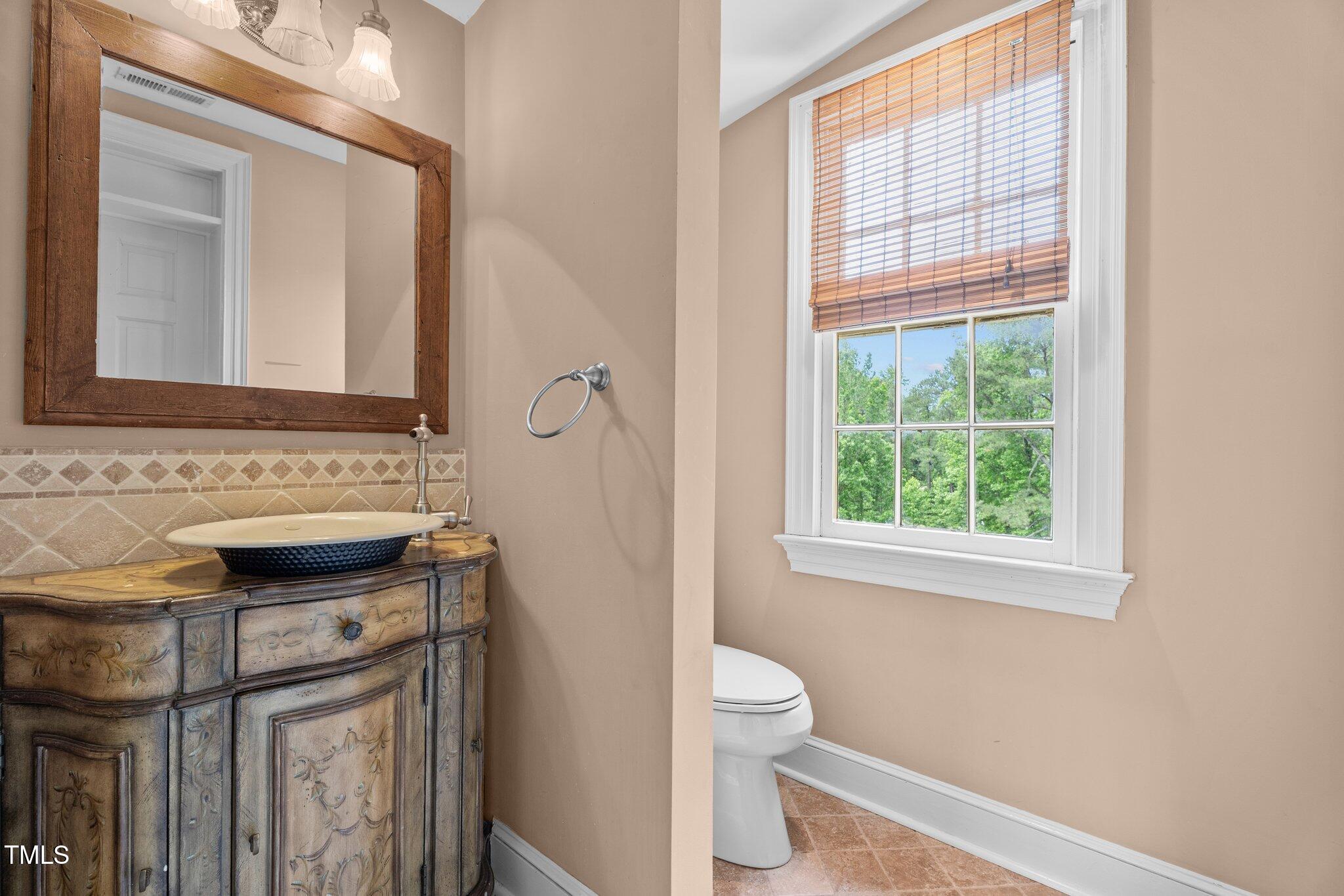 7404 Halifax Road Zebulon, NC 27597 - Photo 31 of 39 a bathroom with a sink a toilet and a mirror