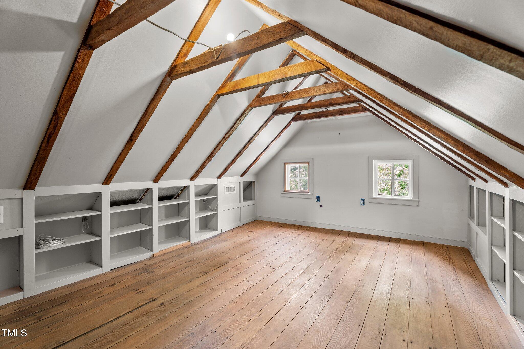 7404 Halifax Road Zebulon, NC 27597 - Photo 32 of 39 a view of an empty room with wooden floor and windows