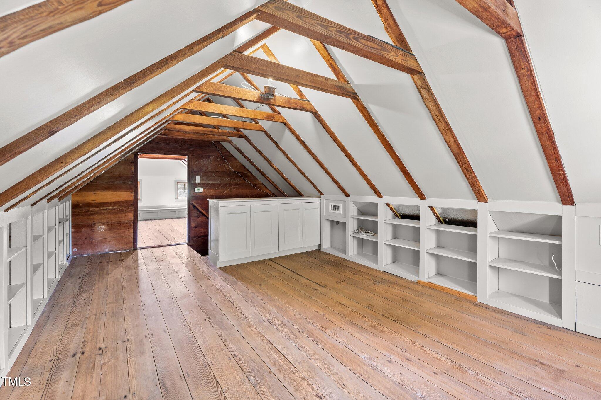 7404 Halifax Road Zebulon, NC 27597 - Photo 34 of 39 a view of an empty room with wooden floor and door