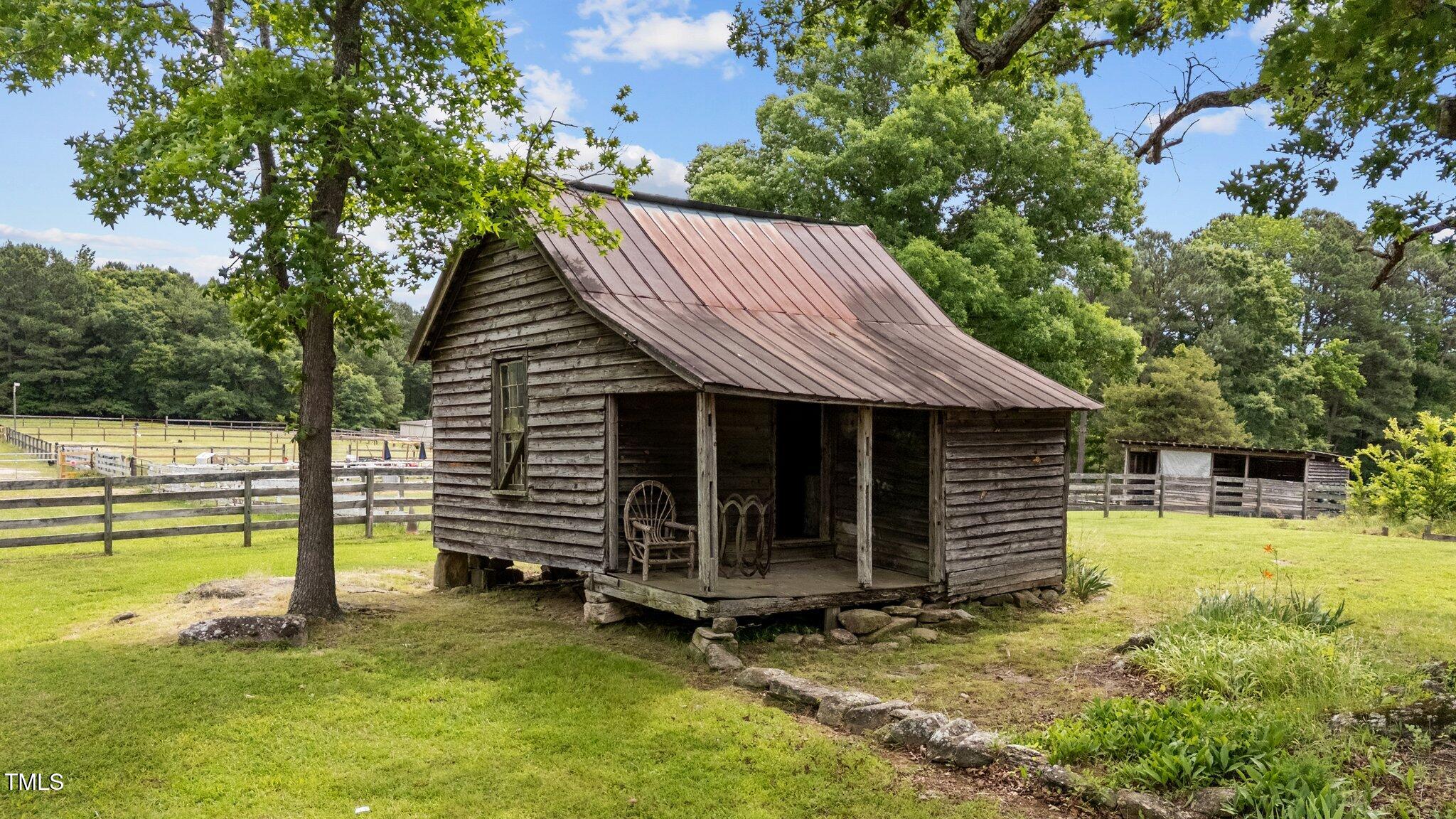 7404 Halifax Road Zebulon, NC 27597 - Photo 36 of 39 a view of a house with a backyard and a tree