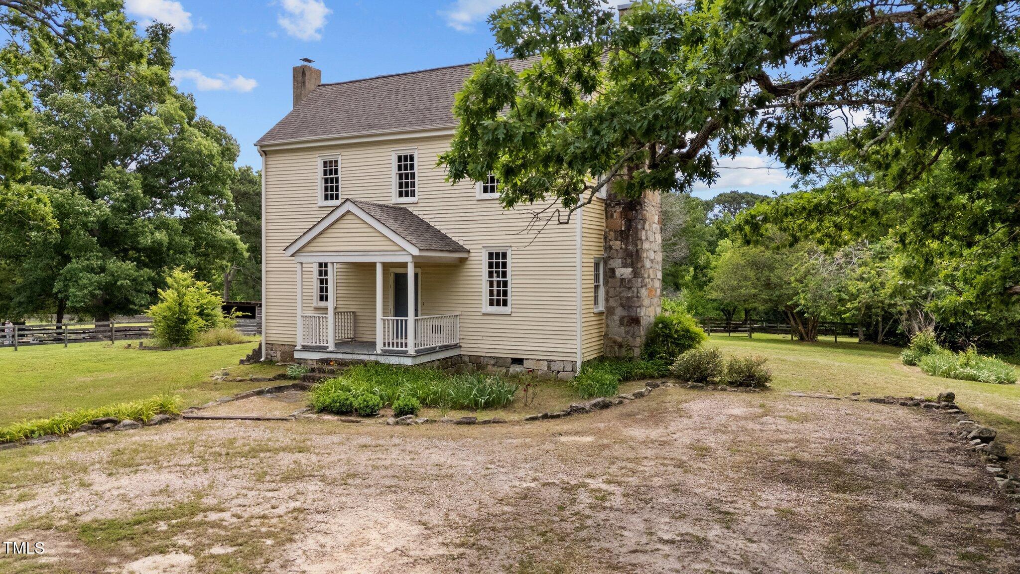 7404 Halifax Road Zebulon, NC 27597 - Photo 4 of 39 a front view of a house with garden