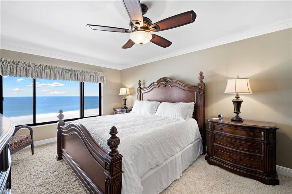 100 North Collier Boulevard, Unit 1201 Marco Island, FL 34145 - Photo 11 of 26 a bedroom with a bed a chandelier and large window