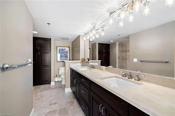 a bathroom with a double vanity sink and a mirror