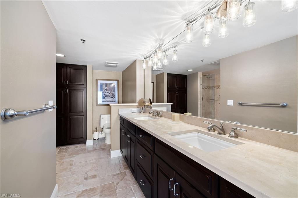 100 North Collier Boulevard, Unit 1201 Marco Island, FL 34145 - Photo 15 of 26 a bathroom with a double vanity sink and a mirror
