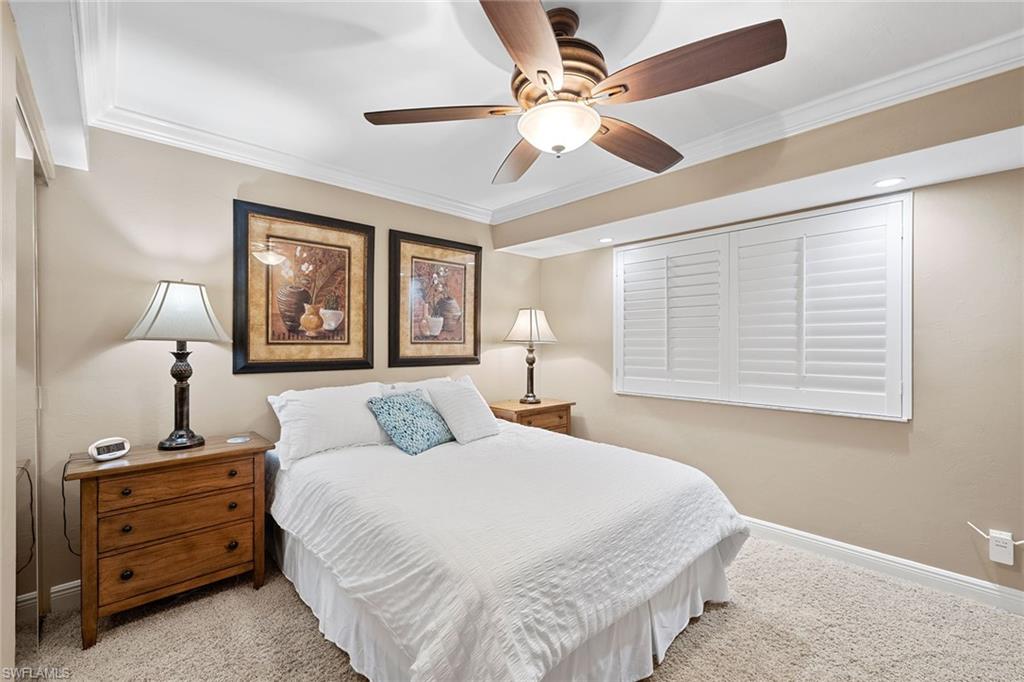 100 North Collier Boulevard, Unit 1201 Marco Island, FL 34145 - Photo 20 of 26 a bedroom with a large bed and a chandelier