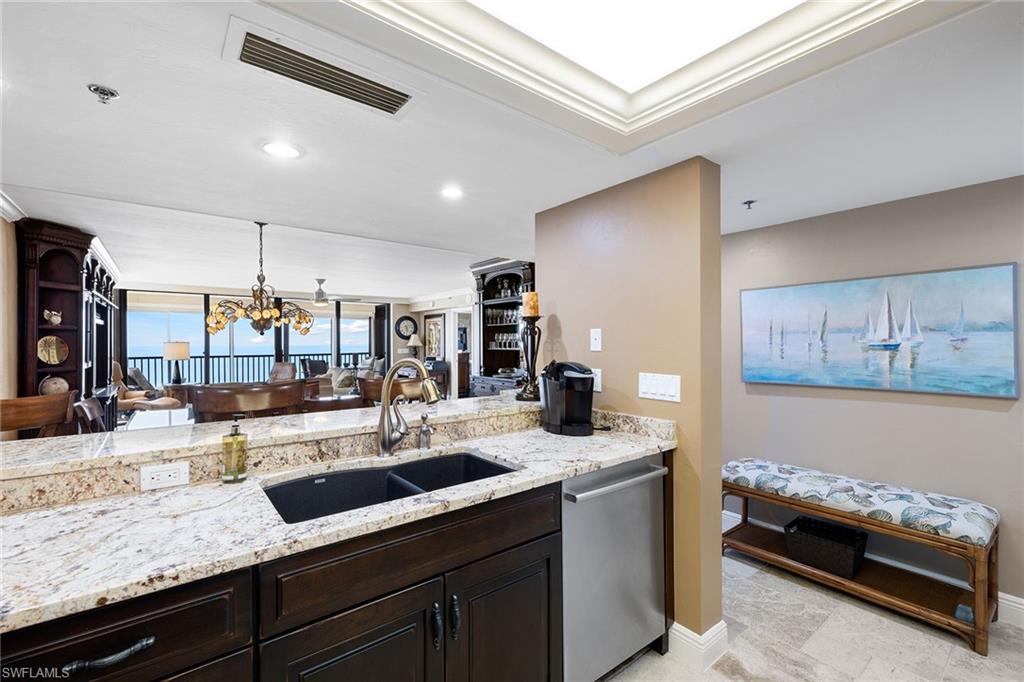 100 North Collier Boulevard, Unit 1201 Marco Island, FL 34145 - Photo 10 of 26 a kitchen with a sink a counter space appliances and cabinets