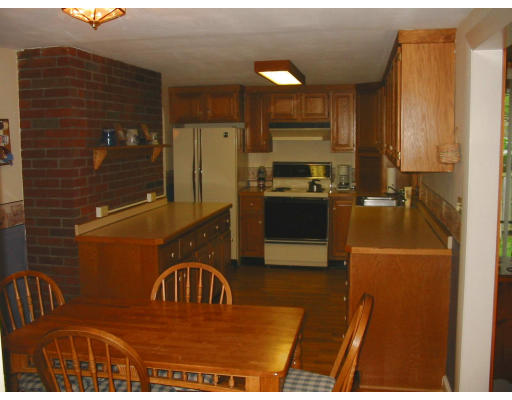 2 Anna Road Woburn, MA 01801 - Photo 6 of 6 a kitchen view with granite countertop a refrigerator a stove top oven a sink and dishwasher