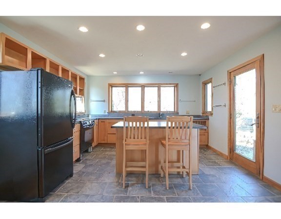 55 Lookout Point Road Plymouth, MA 02360 - Photo 15 of 42 a kitchen with stainless steel appliances kitchen island granite countertop a refrigerator a table and chairs
