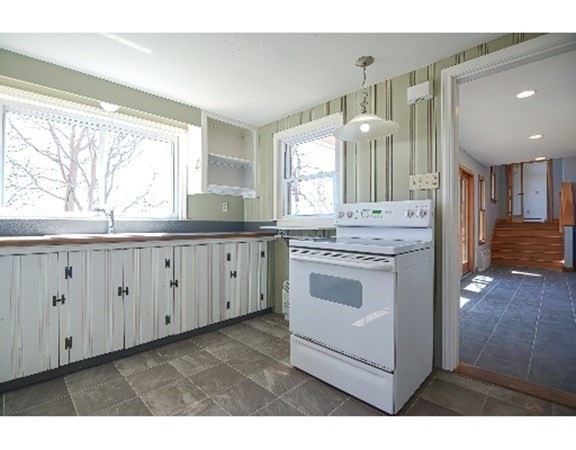 55 Lookout Point Road Plymouth, MA 02360 - Photo 23 of 42 a kitchen with granite countertop white cabinets and white appliances