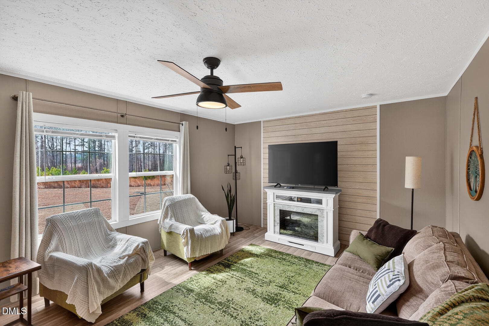 540 Pine Ridge Road Zebulon, NC 27597 - Photo 77 of 96 a living room with furniture a flat screen tv and a fireplace