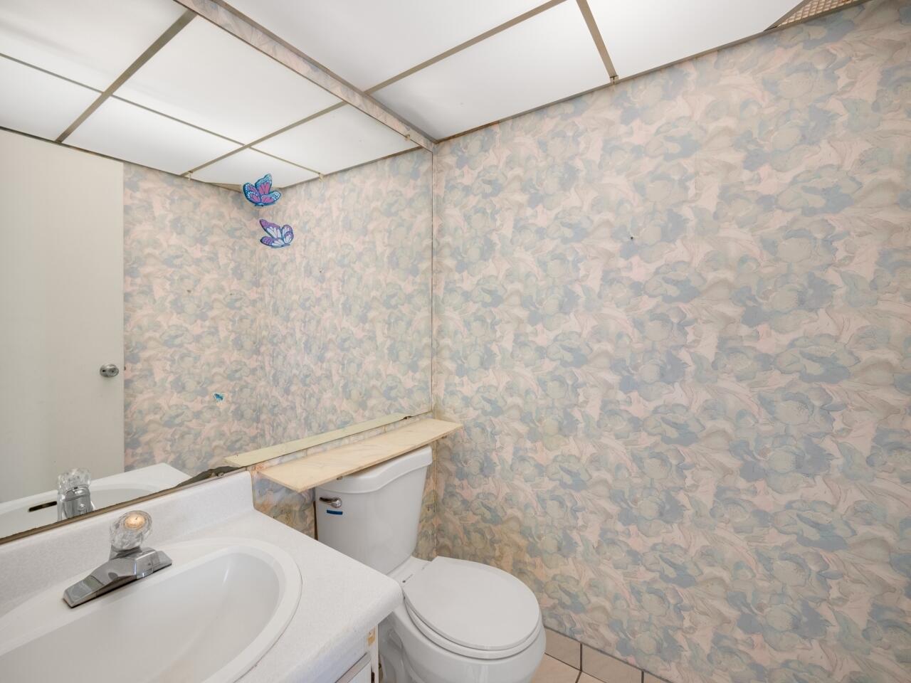 438 Monaco J Delray Beach, FL 33446 - Photo 14 of 15 a bathroom with a sink a toilet and shower