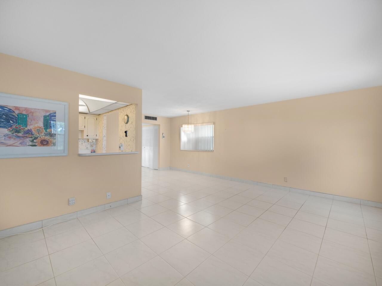 438 Monaco J Delray Beach, FL 33446 - Photo 3 of 15 an empty room with window and mirror