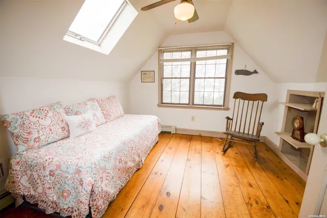 a bedroom with a bed a chair and a window