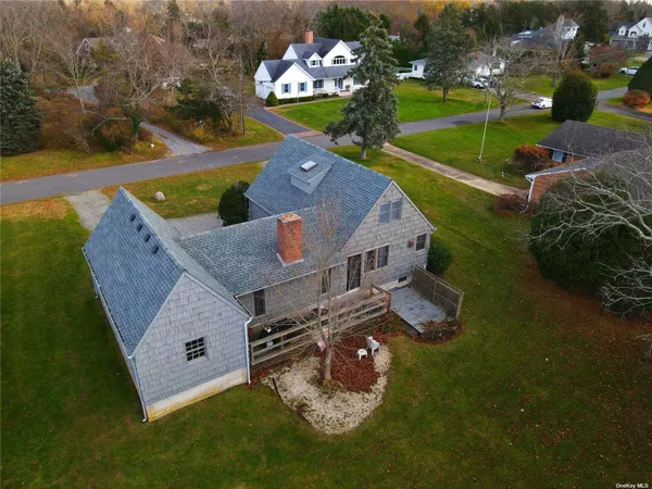 an aerial view of a house with garden space and ocean view