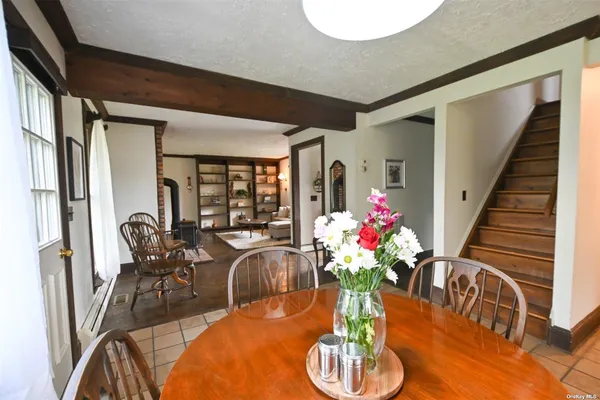 a dining room with furniture potted plants and wooden floor