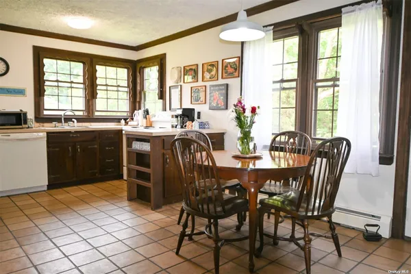 a view of a dining room with furniture and windows