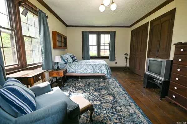 a bedroom with a bed and a book shelf