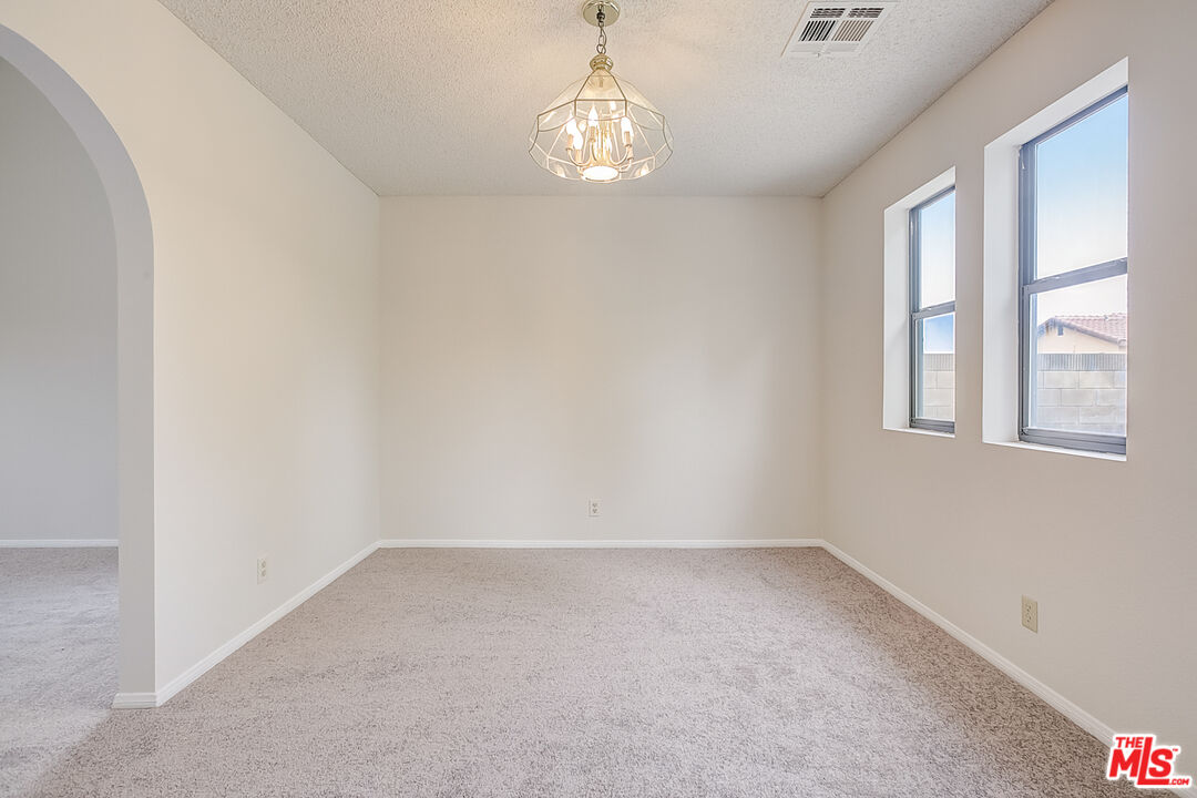 2535 West Ave K9 Lancaster, CA 93536 - Photo 12 of 35 wooden floor in an empty room with a window