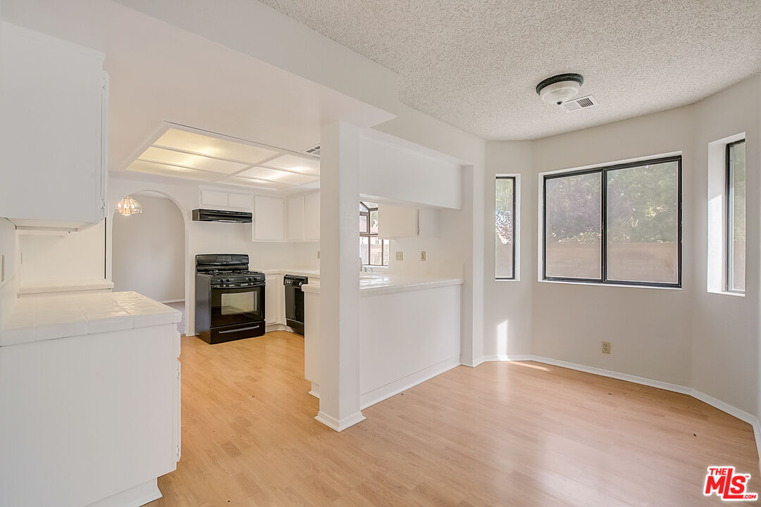 2535 West Ave K9 Lancaster, CA 93536 - Photo 19 of 35 a view of a kitchen with furniture and an empty room