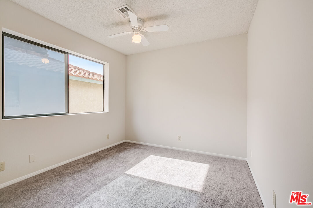 2535 West Ave K9 Lancaster, CA 93536 - Photo 27 of 35 an empty room with windows and fan